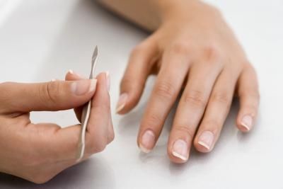 hands with manicure tool