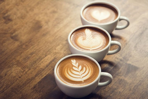 Premium Photo  Two glasses coffee cup with cappuccino in morning on white  table with latte art aroma ristretto mug of coffee glass close up top view  ceramic cup of coffee on