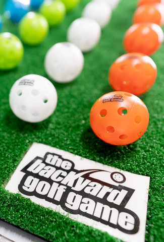 The Backyard Golf Game plastic balls and hitting mat