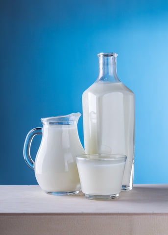 cow's milk in 3 different cups on a counter