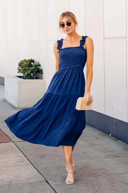 model wearing a navy tiered maxi dress