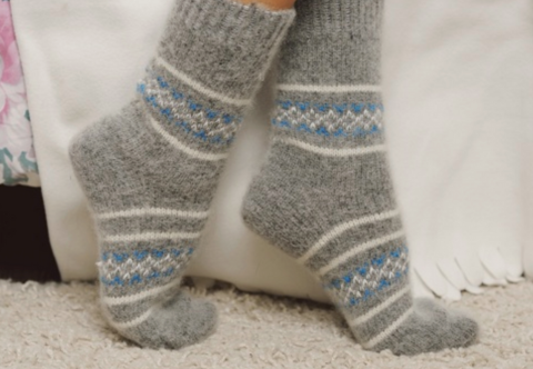 Woman's feet wearing grey wool socks.