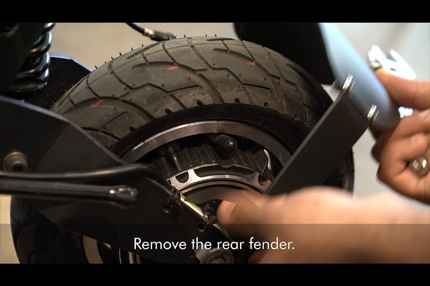 Unfasten the nut and remove the rear fender on the other side of the e-scooter tyre.