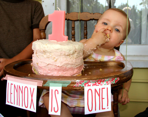 baby eats her ombre pink strawberry birthday cake from washi tape decorated tray