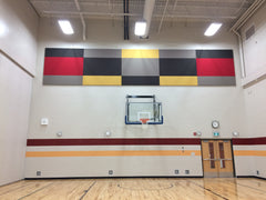 red, black and yellow acoustic panels in gym