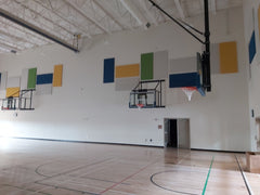 yellow, blue and white acoustic panels in a gymnasium