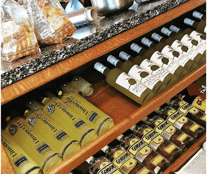 Luxury liqueur on wooden shop shelves, including bottles of Lemon Brothers’ signature Limonceflo.