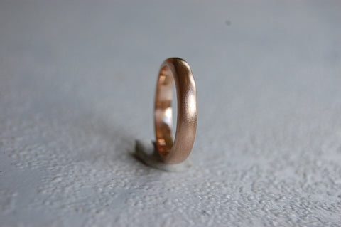 An example of a rose gold wedding band, showing people the more rose colored version of gold. 