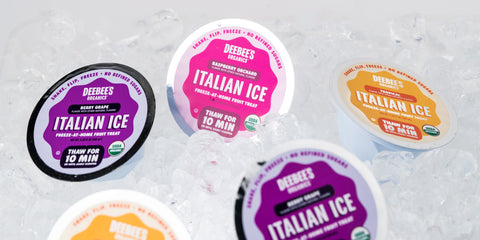 An image of five DeeBee’s Organics Italian Ice cups sitting atop a bed of ice.