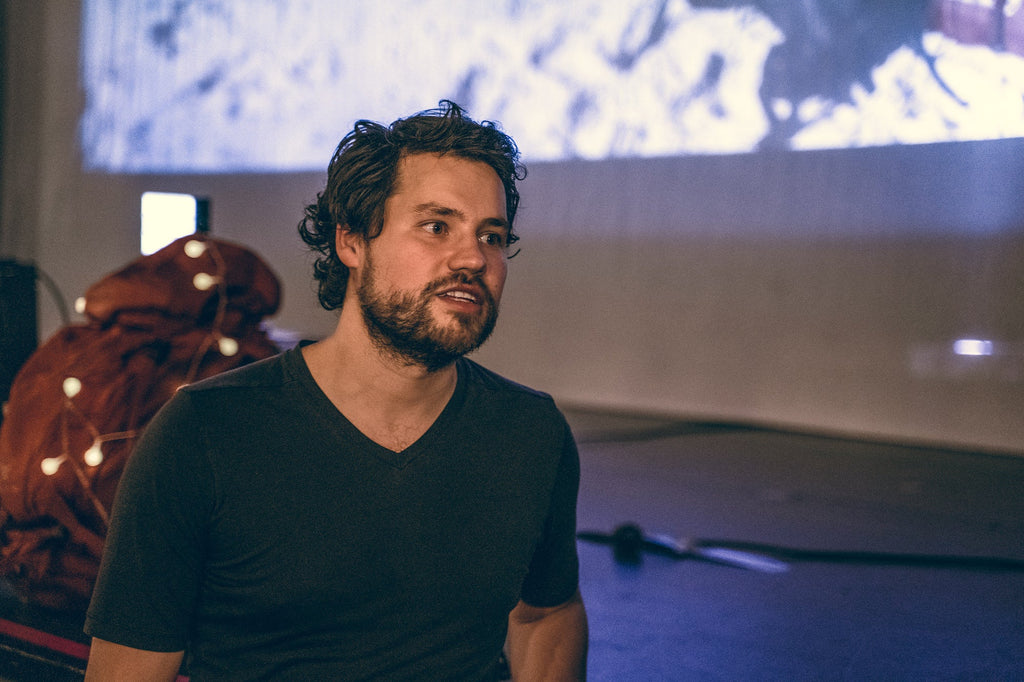 Half-length portrait of Vitaly sitting in front of his slide show.