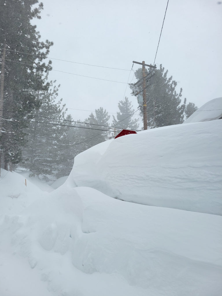Stop Sign buried by snow in Mammoth Lakes winter 2023