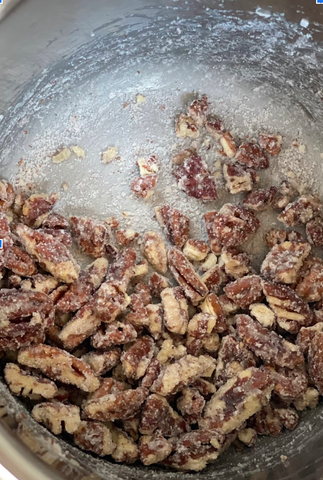 the process of roasting pecans where the sugar stands out white on the pecans