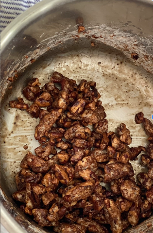 the process of roasting pecans near the end where they turn dark in the pot