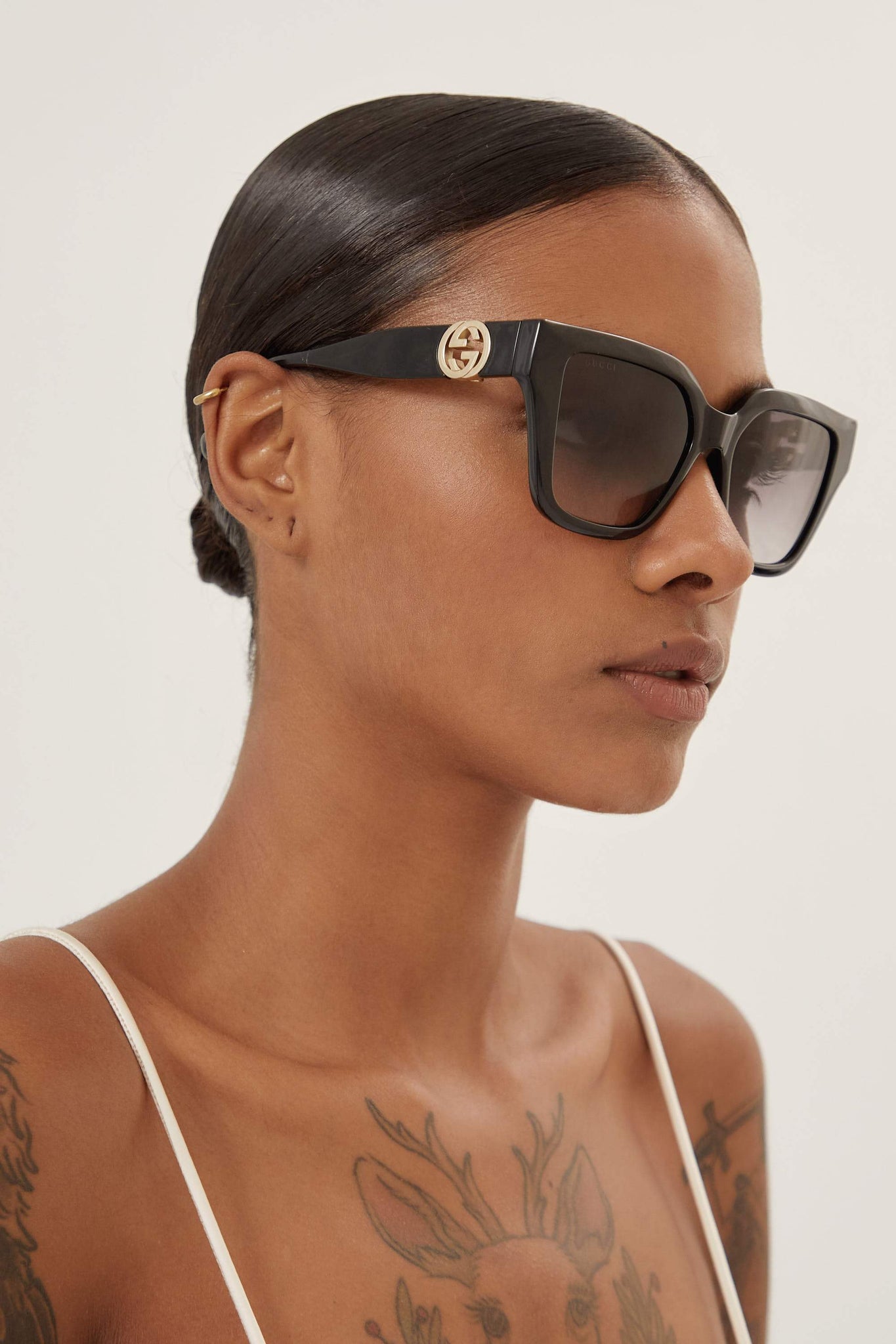 Gucci cat-eye black sunglasses with integrated GG logo