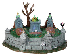 Lighted zombies pop out of the ground in this cemetery scene and plot their revenge on the living. The tombstones, detailed stone work, owl, vulture and skulls add an extra spooky touch.