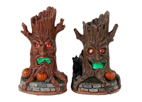 Lemax Spooky Town Haunted Tree Trunks #34072 - two sinister looking tree trunks have red eyes and green glowing mouths.