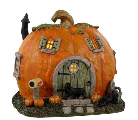 If there was one place in Spooky Town we could choose to live it would have to be the Pumpkin Cottage. Adorable and inviting looking this home is a carved pumpkin complete with windows and a cute hobbit-style door. The lights glow from within for a warm welcome and two black cats lounge around the front door amid cheery jack-o'lanterns. Sweet and certainly less frightening than some of the other homes around town this cottage is as charming as can be.
