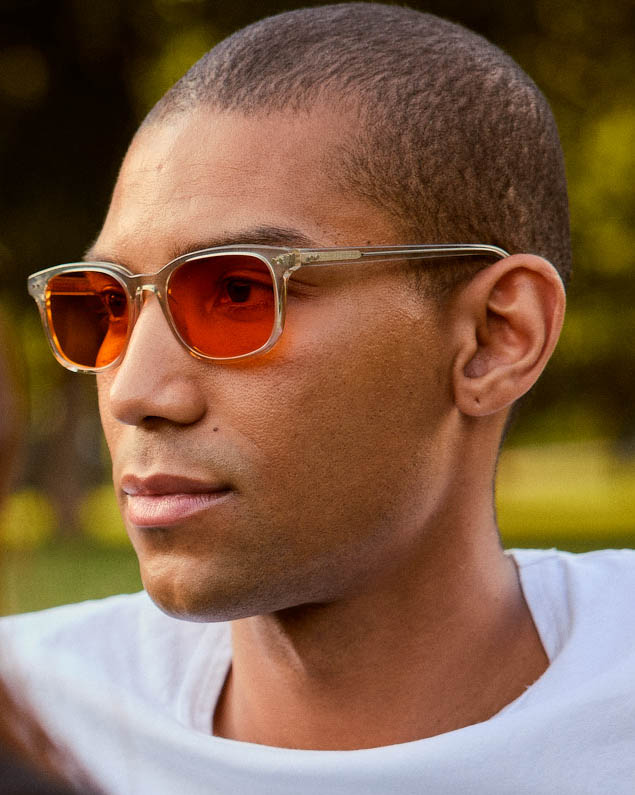 Model is wearing Filter Optix blue blocking glasses with Orange lenses