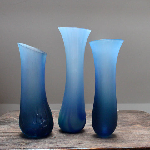 Three blue glass vessels made by glass artist Ruth Shelley 