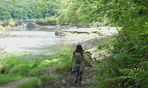 artist Siobhan Purdy walking beside a Cornish river 