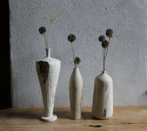 wooden bottles with dried flowers in them made by Jayne Armstrong