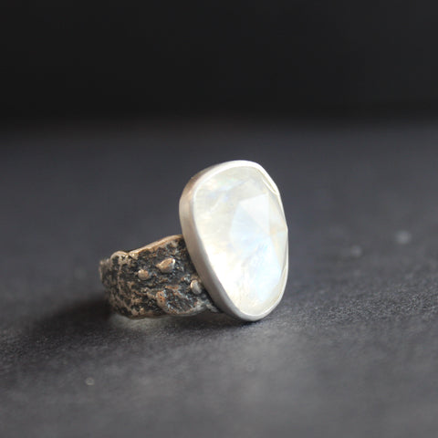 silver ring with a large white coloured stone