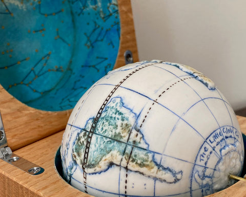 close up detail of a small globe in an oak box by Loraine Rutt of the Little Globe Company 