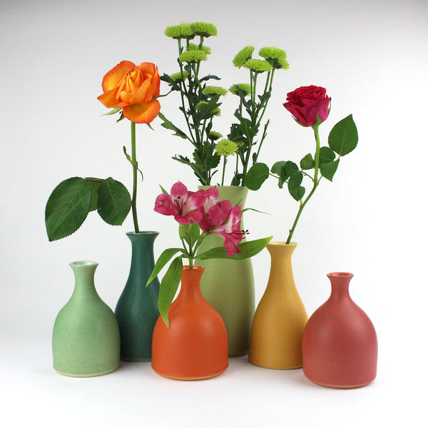 a collection of Lucy Burley ceramic bottles and vases in bright spring colours 