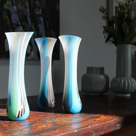 Three multicoloured tall glass vessels by Ruth Shelley 