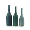A trio of Lucy Burley ceramic bottles in shades of teal  on a white background