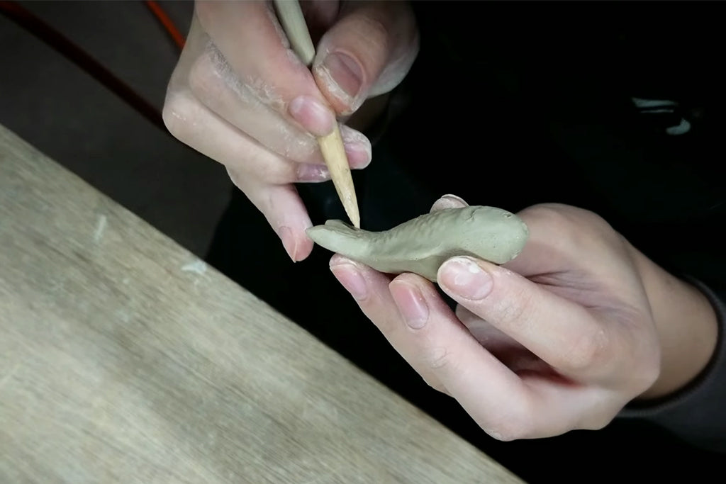 Scales and fins are carefully carved on the molded carp