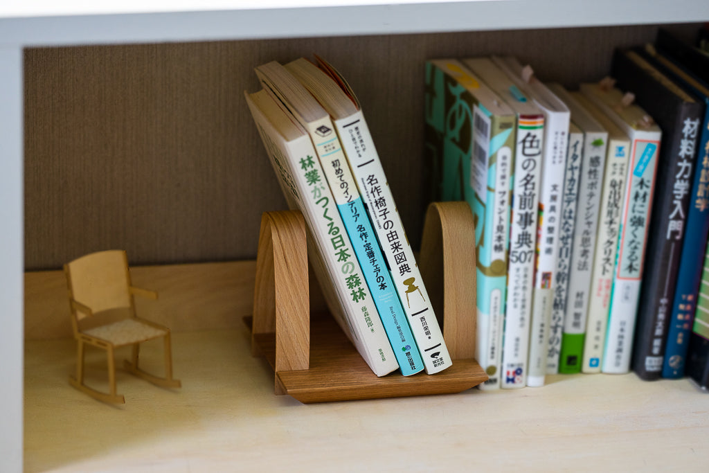 A book stand that can also be used as a bookend using the weight of the book