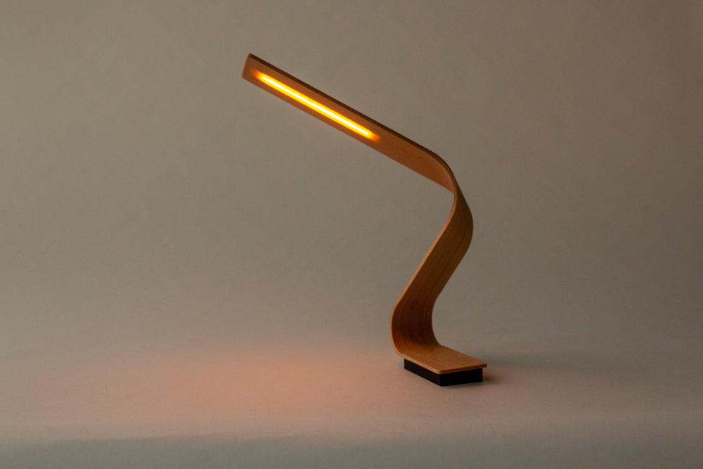 Twisted lamp with gentle light that penetrates the beech tree