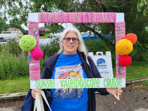 Woman holding frame for Sunset Kaleidoscope Cruise