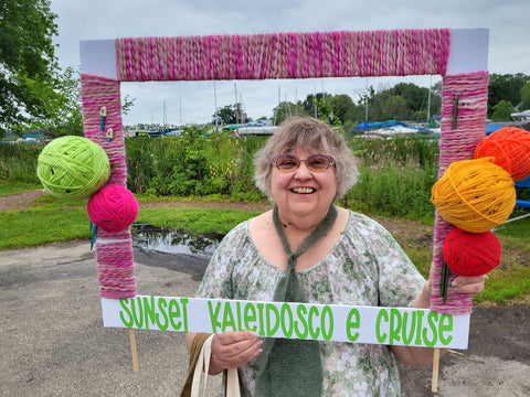 Woman holding frame for Sunset Kaleidoscope Cruise