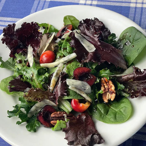 Green salad using spring mesclun lettuce, blue jack cheese, cherries and pecans