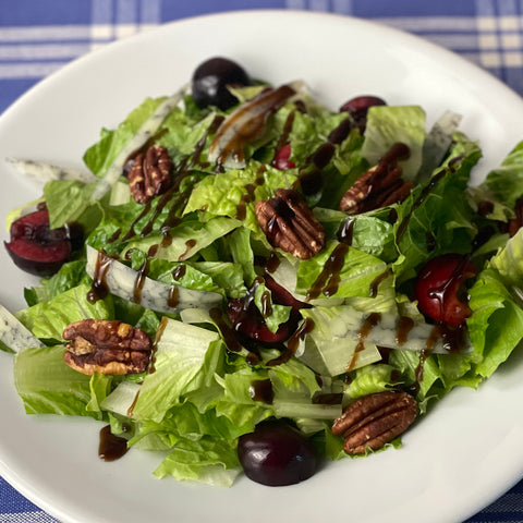 Green salad using romaine, pecans, blue jack cheese and fresh cherries