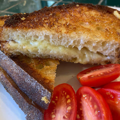 Grilled Cheese sandwich cut on the diagonal, crispy outside and gooey inside