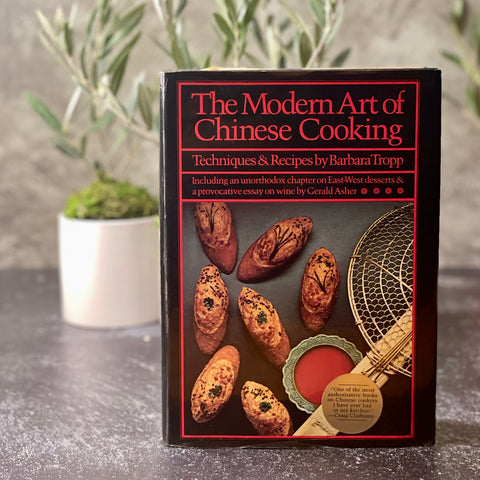 Front cover of Barbara Tropp's book, the Modern Art of Chinese Cooking, a few olive trees are in the background