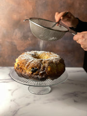 Donald dusts the brioche with confectioner's sugar