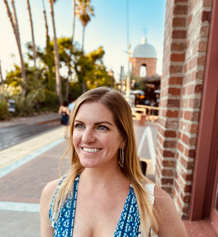 Rebecca Keni at San Juan Capistrano train station. Blue dress sunny skies.