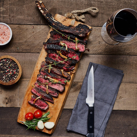 Bone-in steak grilled perfectly and sliced for serving