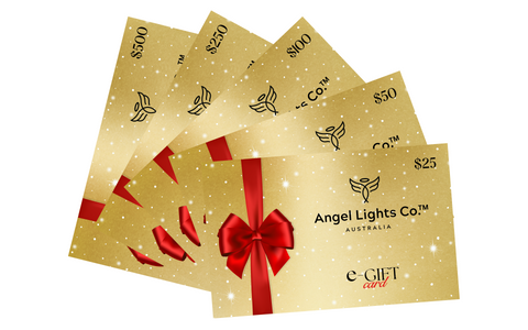 coloured image of an example of angel lights co. digital gift cards that are in a fanned out position. It shows $25, $50, $100, $250 and $500 digital gift cards.