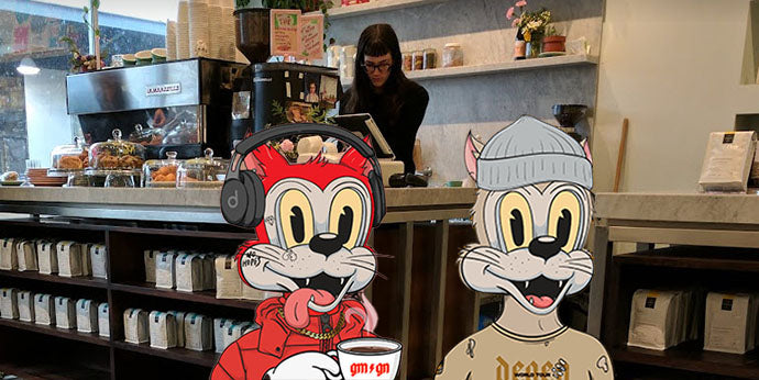 Two cartoon cats in coffee shop