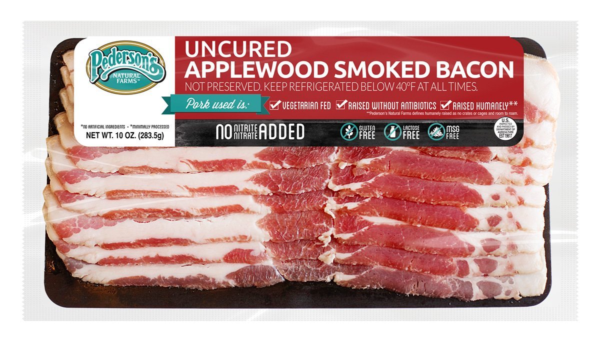 A photo of our Uncured Applewood Smoked Bacon, with red and white packaging containing nutrition info and other information! The net weight of the bacon is 10 OZ, or 283.5g. The packaging states: 