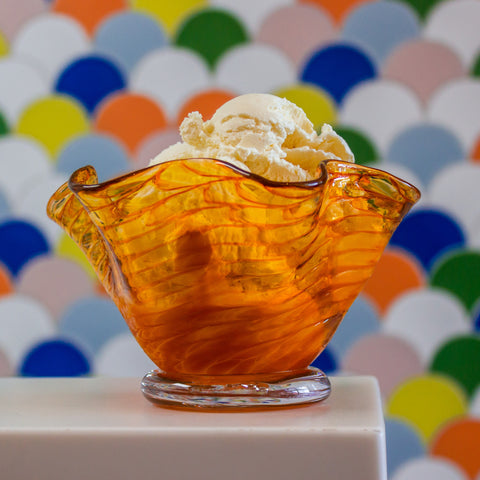 A flutter dish over a colorful background.