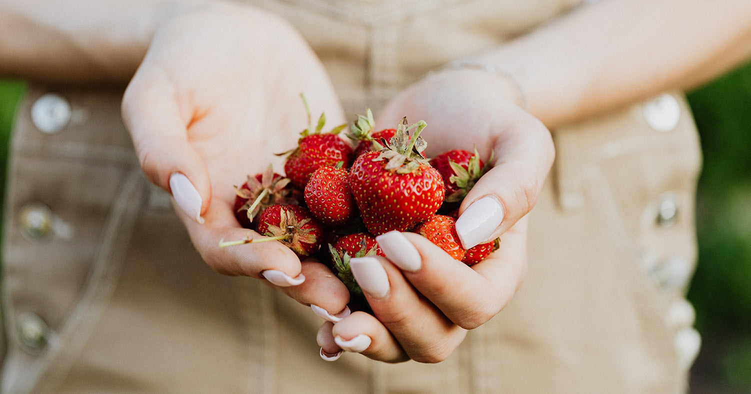 woman holds delicious strawberries