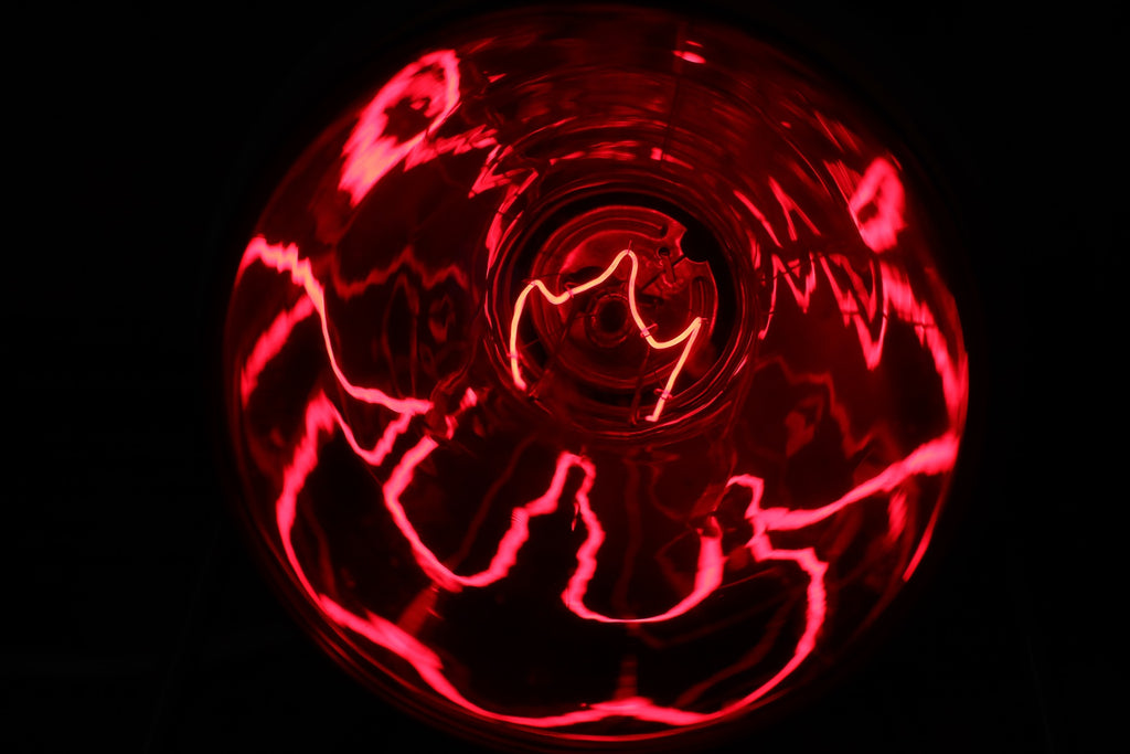 A closeup of a red light bulb filament