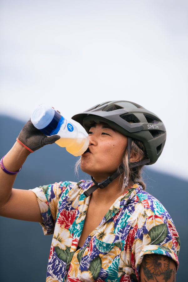 mountain biker drinking gnarly hydrate from squeeze bottle 