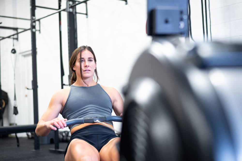 gnarly athlete corinna coffin using the rowing machine in a gym 